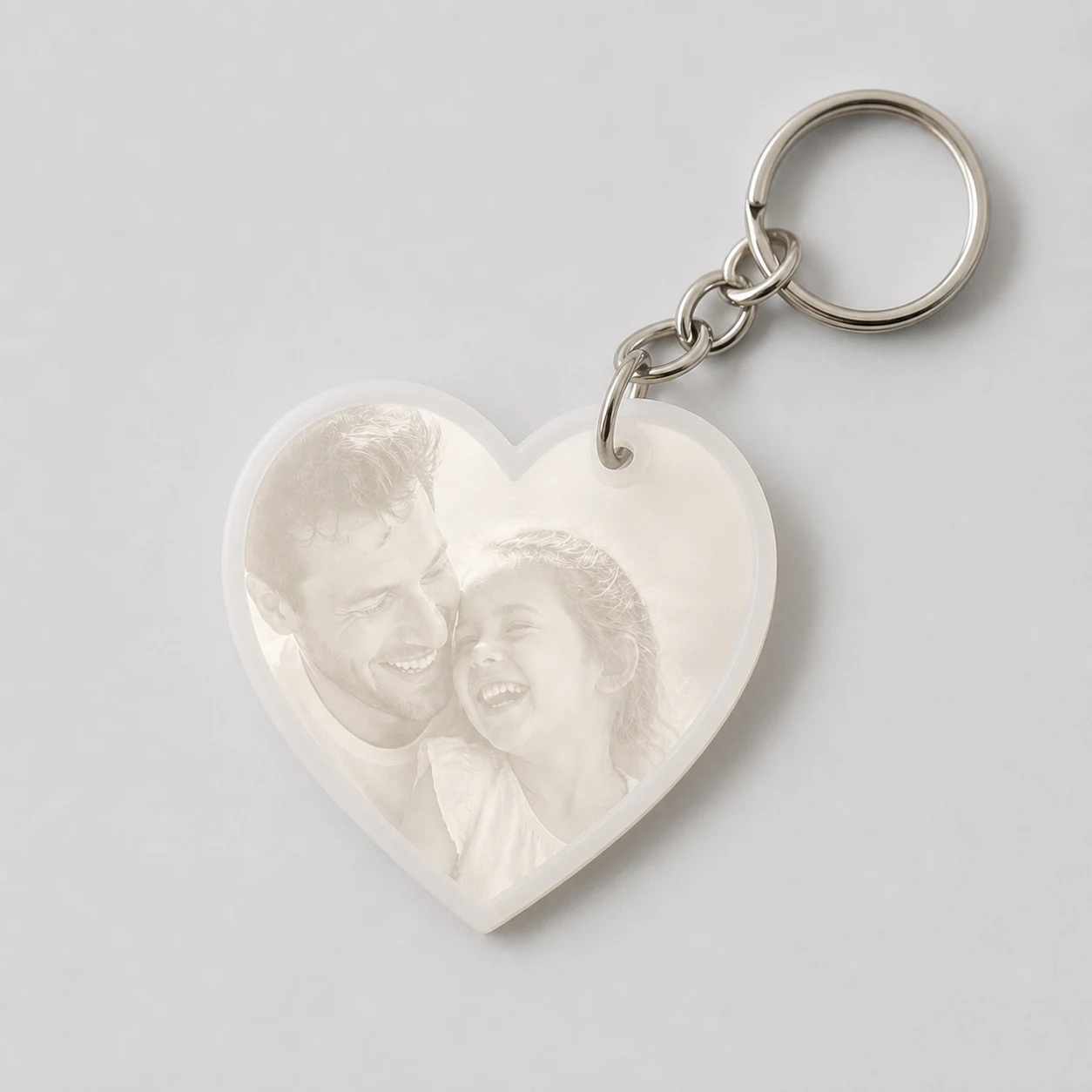 A complete heart lithophane keychain glowing with a father-and-daughter photograph.