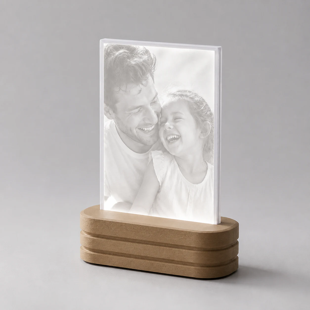 A father and daughter revealed in neutral-white light through a complete Photo Light.